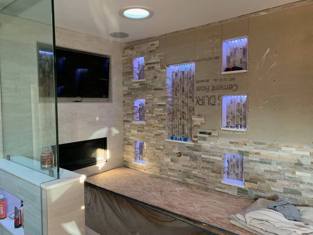 newly remodeled bathroom with textured granite backsplash